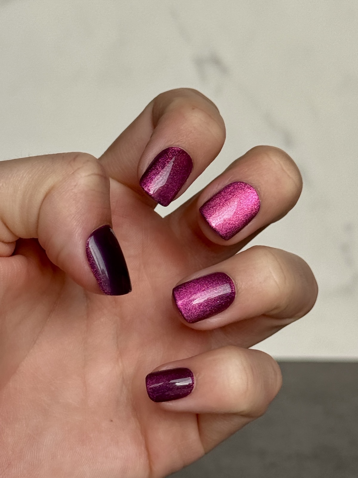 Close-up of Dashing Diva Magic Press nails on a marble surface